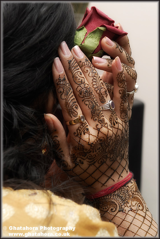 IMG7104 
 Bridesmaid placing a red rose in her hair. Henna by Kiran Chana, Ray of light. 
 Keywords: Bridesmaid placing a red rose in her hair. Henna by Kiran Chana, Ray of light. Henna, mendhi, designs, wedding, indian bride, hands, patterns, fashion, body art, tattoo, hands, colour, Bhupinder Ghatahora, Ghatahora Photography