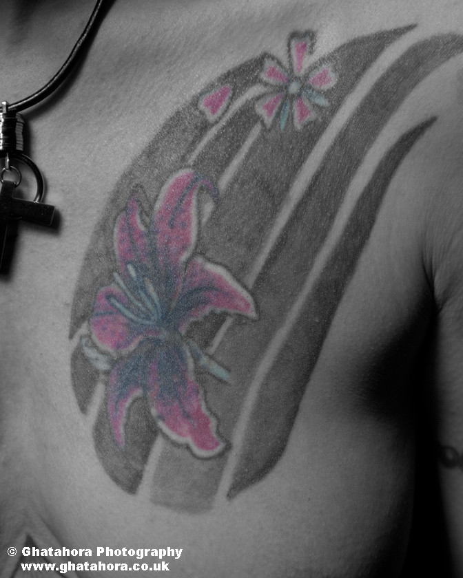 ANI8551 
 Pink lilly on the chest. Romantic Tattoos by Bhupinder Ghatahora 
 Keywords: artisc, glamour, portraits, tattoo, tribal, tattoos, stars, devil, butterfly, cherry, flowers, fashion, models, female, male, ink, colour, body art, flower, lillies, bhupinder ghatahora, romantic tattoos Pink lilly on the ches